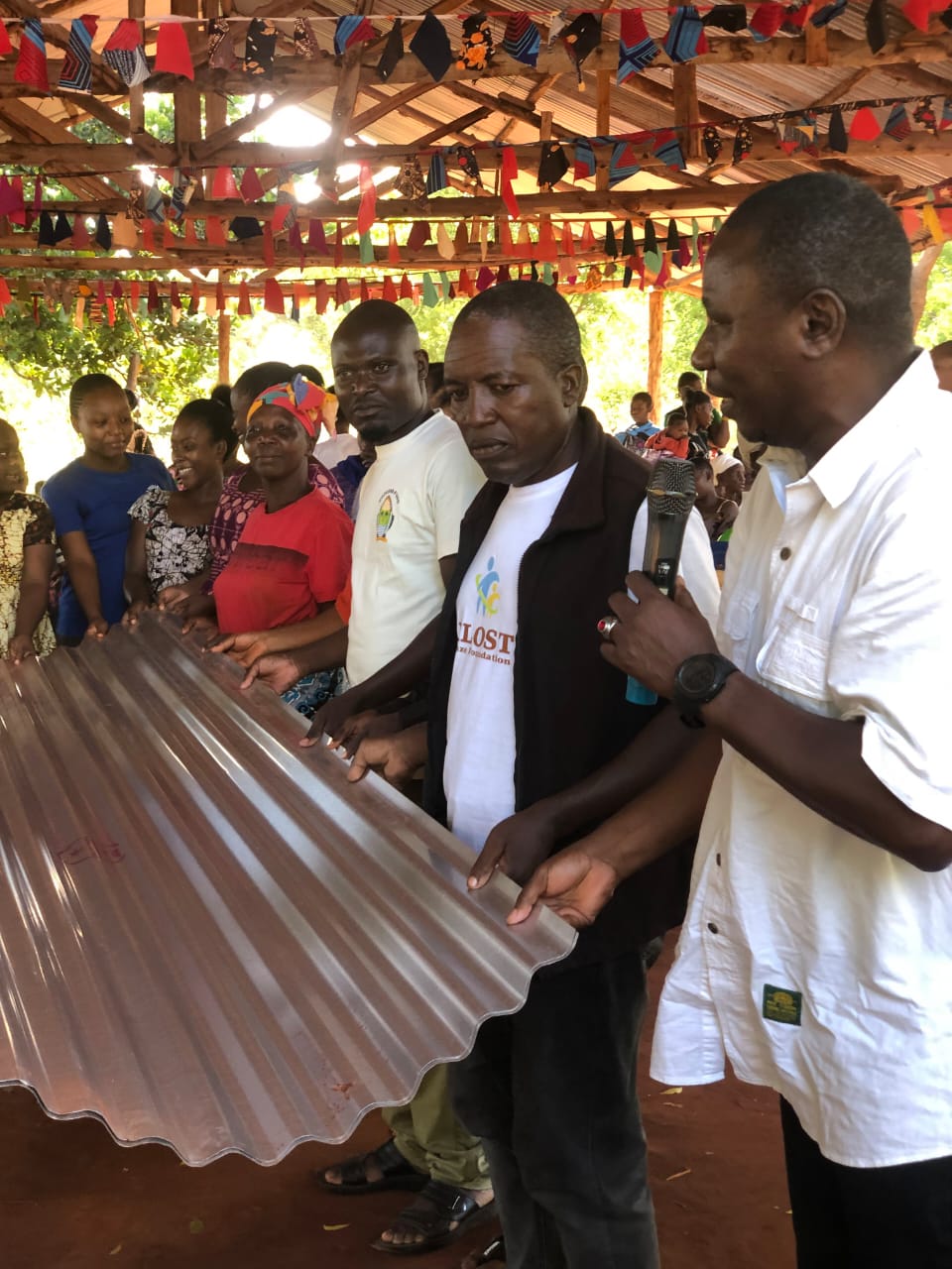 Director of Arlom Safaris, Anderson Kenga Mweni-Arloste handing over Iron Sheets to Bethel Church, Mpirani, Nyari Sublocation